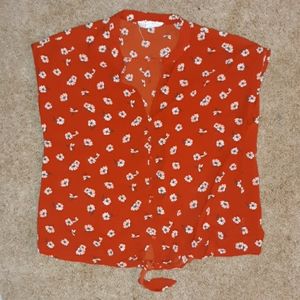 A Siena orange blouse with flower design